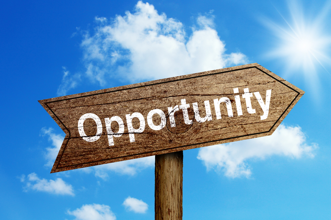 Opportunity-wooden-road-sign-shining-blue-sky-background