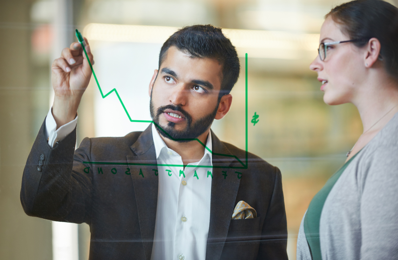 Businessman drawing graph for colleague