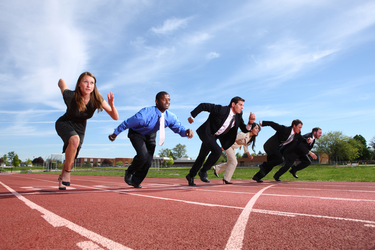 people dressed in business attire racing on track