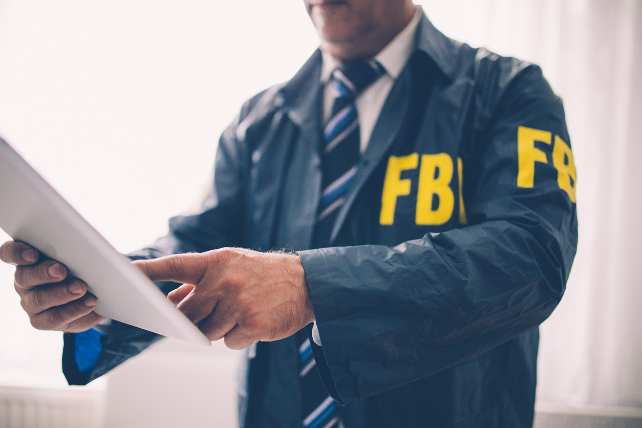 FBI agent working in the office using documents for investigation