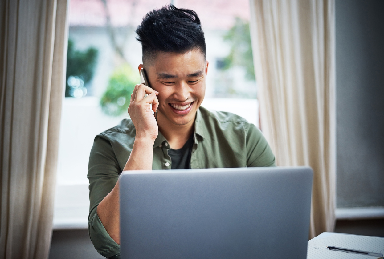 Young man doing an over the phone job interview at home