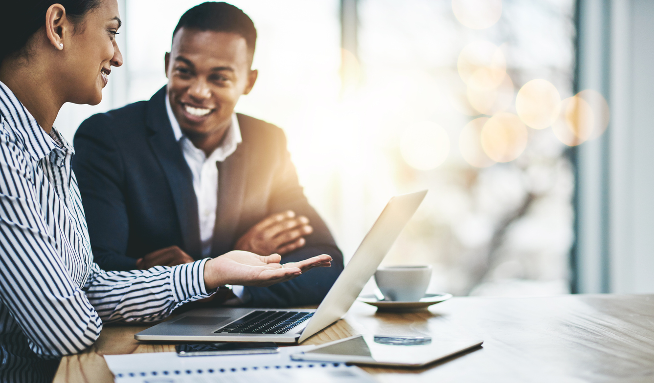 Shot of two businesspeople working together on a laptop in an office