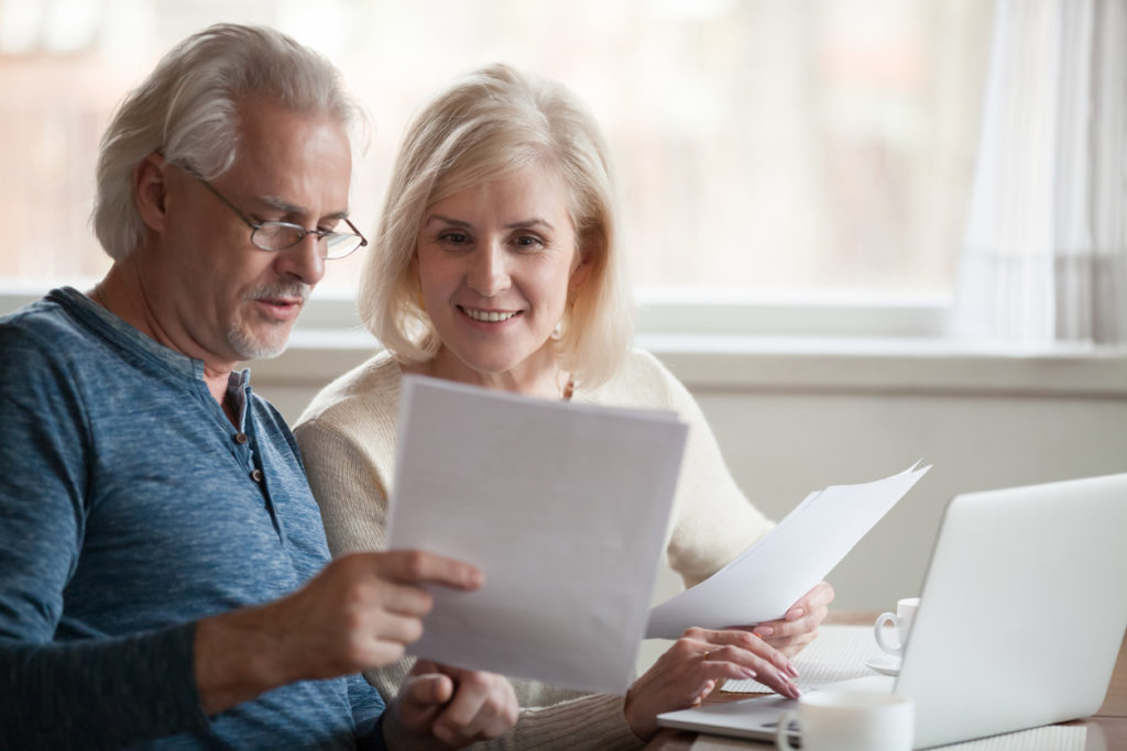 Retiree couple reading a document about re-entering the workforce