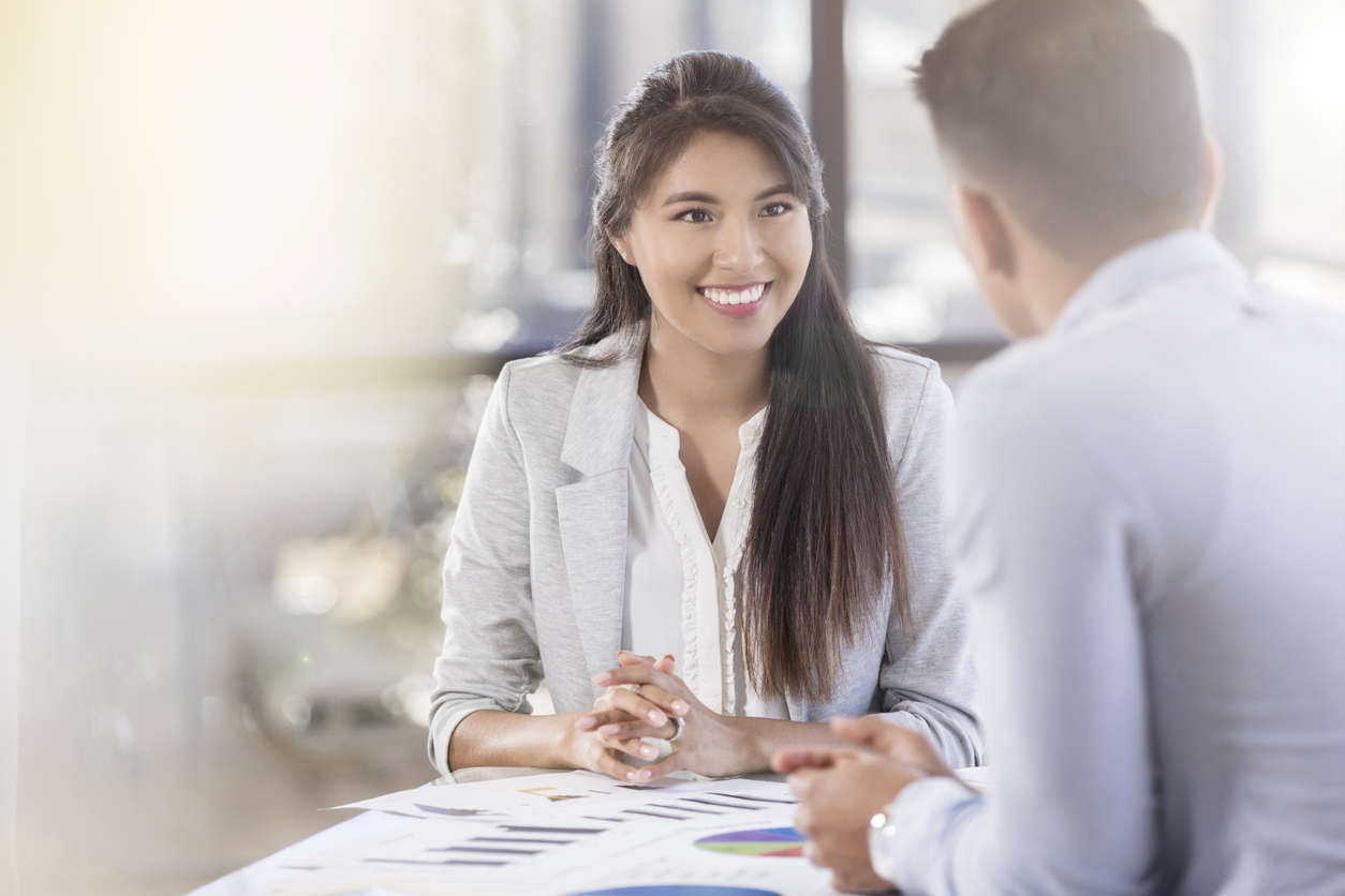Interviewer talking to a prospective accounting professional in a hiring meeting.