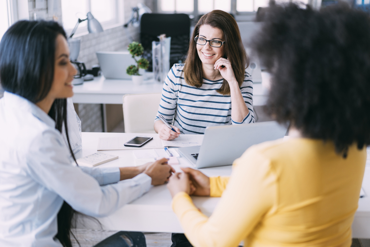 Boutique staffing agency in office talking.