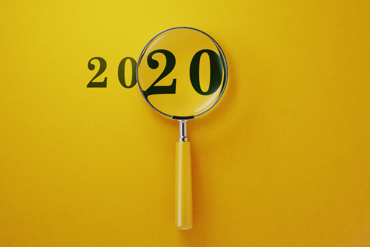 Magnifier and 2020 on yellow background. Horizontal composition with copy space. New Years Resolution for Hiring in 2020
